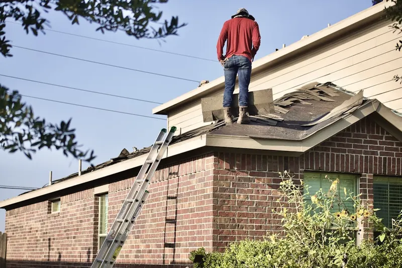 Professional roofer working on a residential roof in Saint Josephs